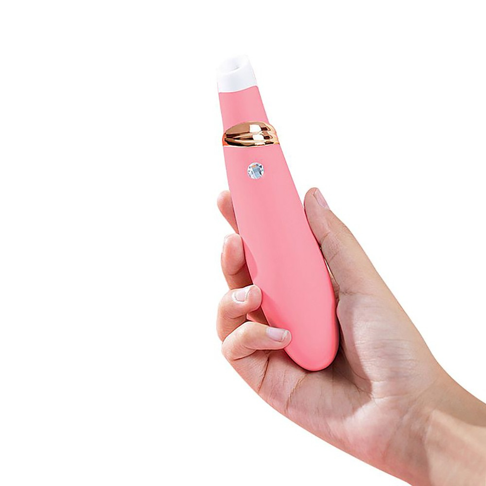 Vibrador e Sugador de Clit�ris Foxy Salm�o, sendo segurado por uma m�o, mostrando o tamanho e a ergonomia