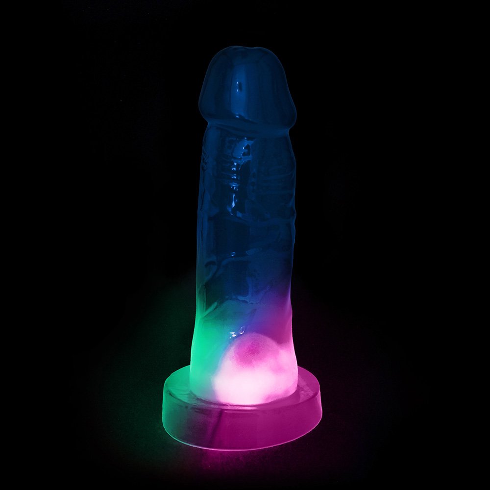 P�nis Pisca Pisca Mimo com Base para Cinta Transl�cido na cor Azul, exibindo as luzes internas e o material flex�vel.