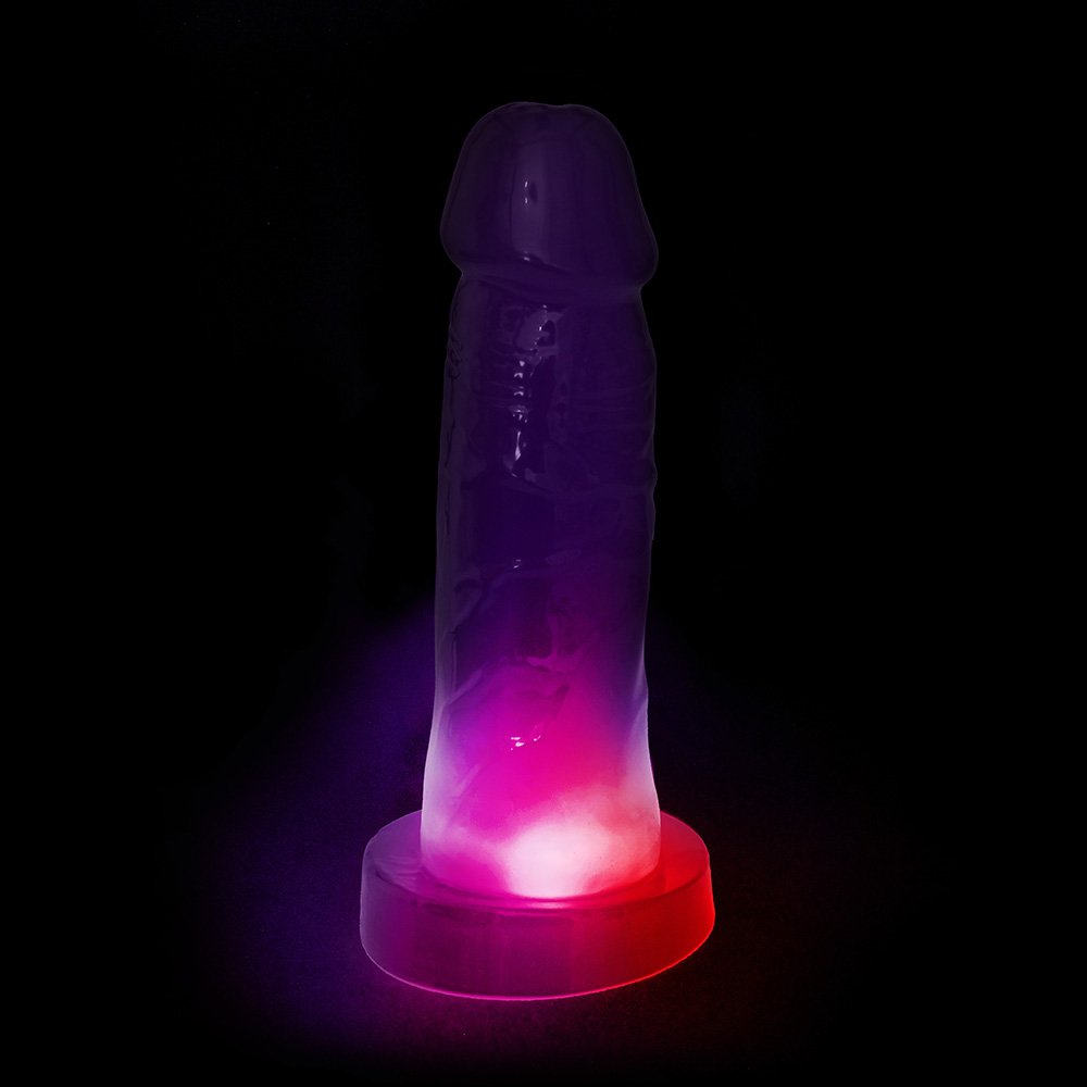 P�nis Pisca Pisca Mimo Transl�cido Roxo em vista frontal, com efeito luminoso ativado e base para cinta.