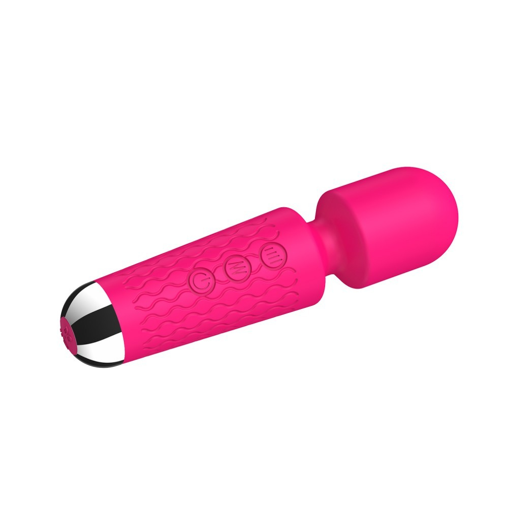 Aparelho inclinado revelando a textura aveludada do silicone, os botoes de controle na lateral e a base metalica do massageador erotico Pink.