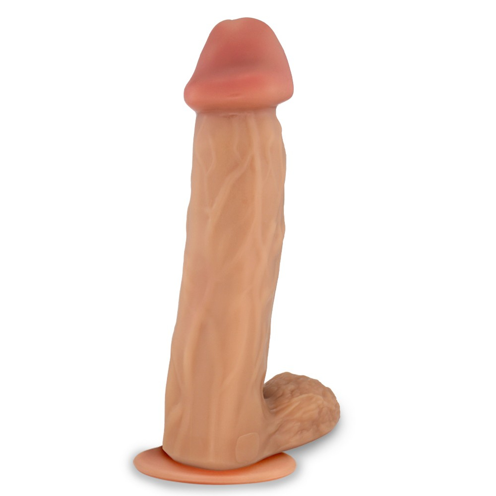 Vista lateral do P�nis Gigante e Grosso Flex�vel com Escroto e Ventosa Valente na cor Bege, evidenciando o comprimento de 31cm, a espessura de 7,8cm, o escroto proeminente e a ventosa na base.